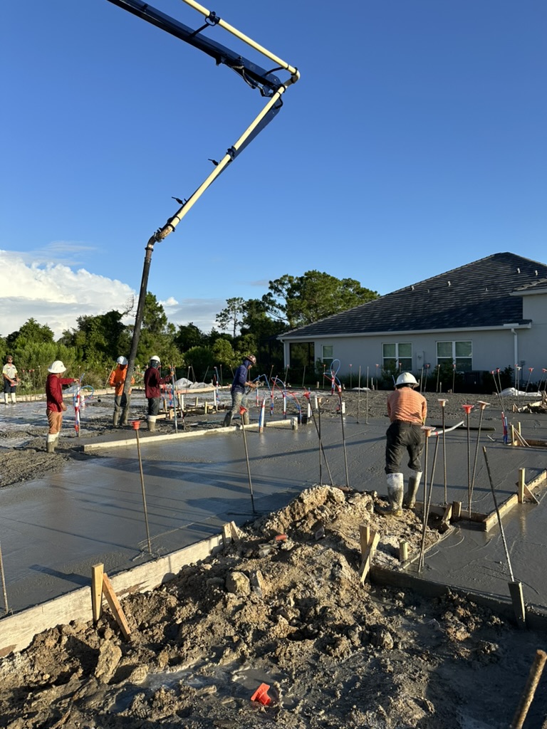 Crew leveling a residential foundation pour.